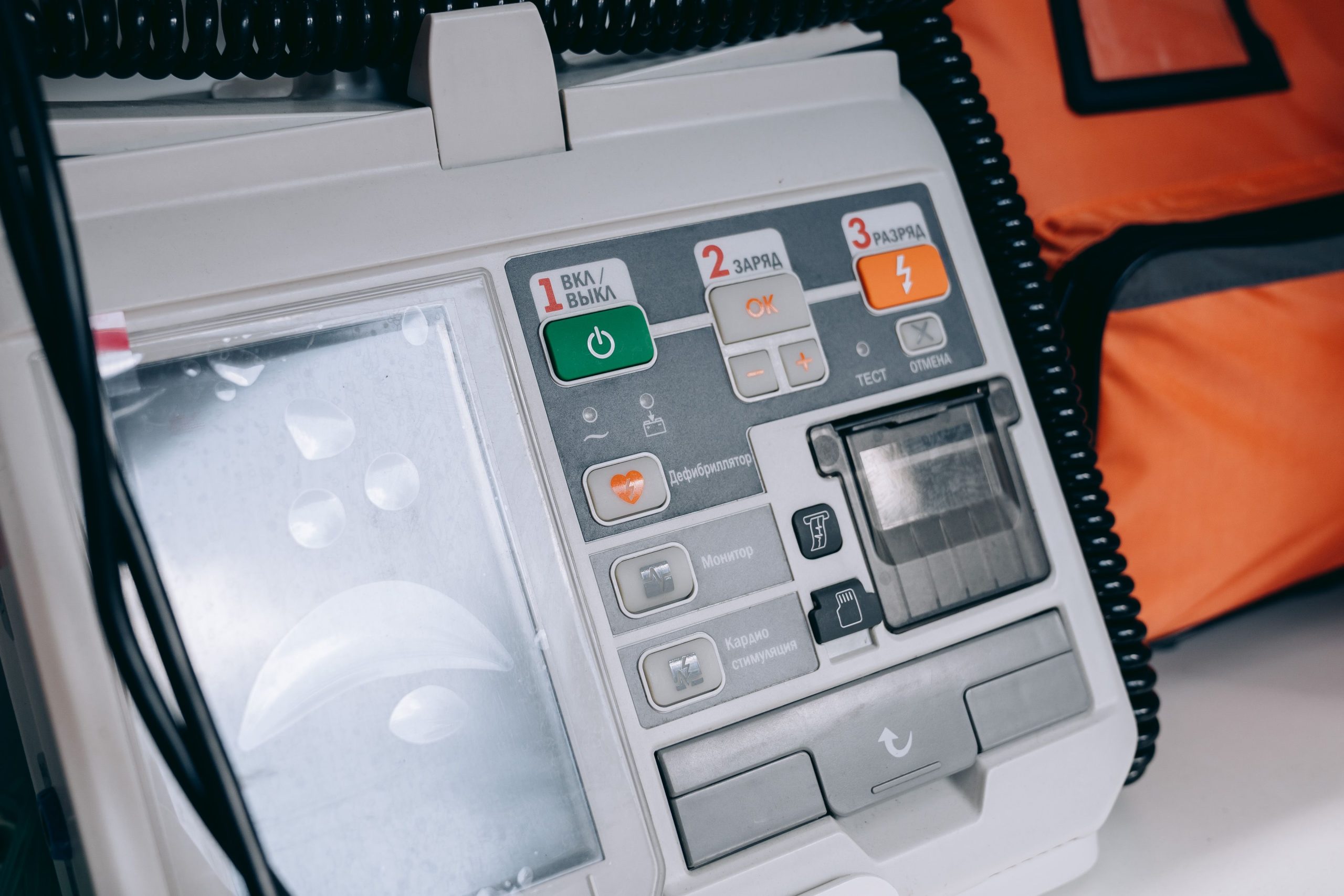 Applications Close-up of a modern medical defibrillator with control buttons and cables.